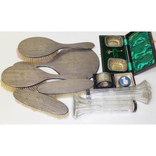 307 - Assorted hallmarked silver comprising a dressing tables set, a cased serviette ring, a pair of salts... 