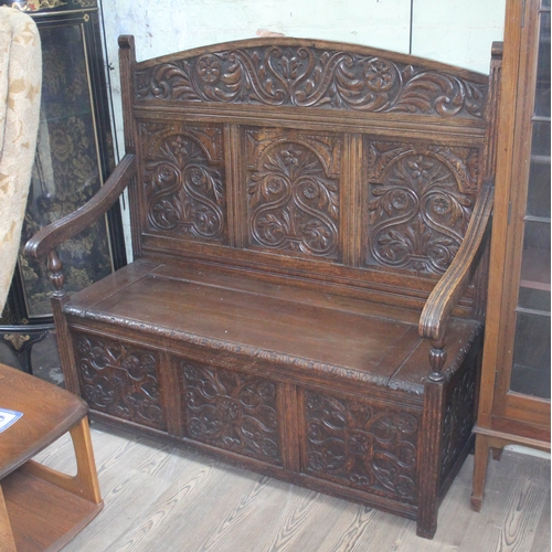 70 - A carved oak settle, circa 1900, width 122cm, depth 56cm & height 119cm.