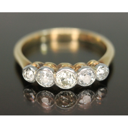 311 - A five stone diamond ring, the millegrain bezel set old European cut stones weighing approx. 0.07, 0... 