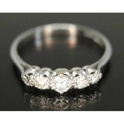 312 - A five stone diamond ring, the round brilliant cut stones weighing approx. 0.07, 0.11, 0.16, 0.10 & ... 