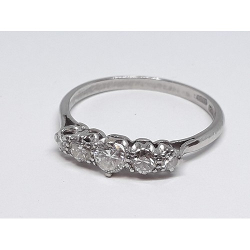 312 - A five stone diamond ring, the round brilliant cut stones weighing approx. 0.07, 0.11, 0.16, 0.10 & ... 