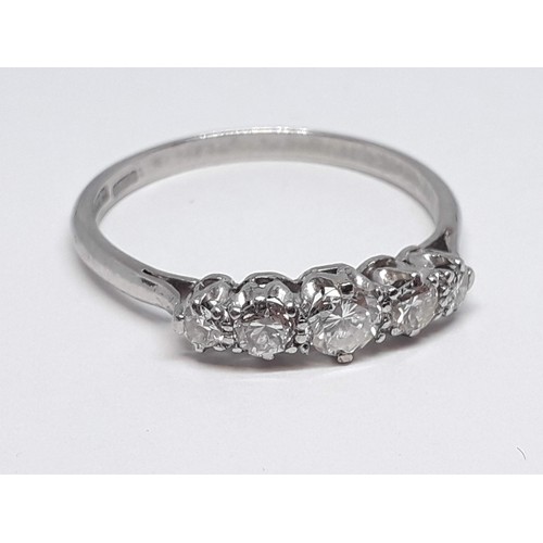 312 - A five stone diamond ring, the round brilliant cut stones weighing approx. 0.07, 0.11, 0.16, 0.10 & ... 