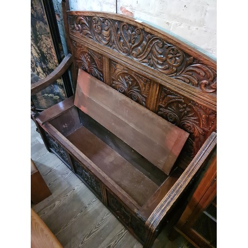 70 - A carved oak settle, circa 1900, width 122cm, depth 56cm & height 119cm.