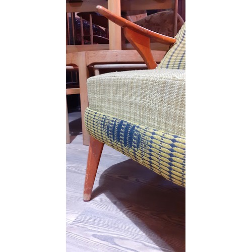 86K - A Swedish armchair with yellow and blue upholstery. 
The chair and the cushion are sprung. The cushi... 