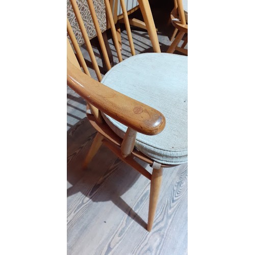 85 - An Ercol Blonde elm and beech drop leaf table and six chairs.