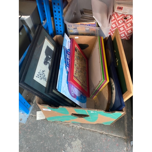 134 - A box of pictures and enameled metal signs.