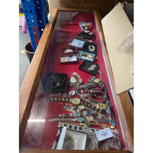 191 - A table top display cabinet with watches and costume jewellery