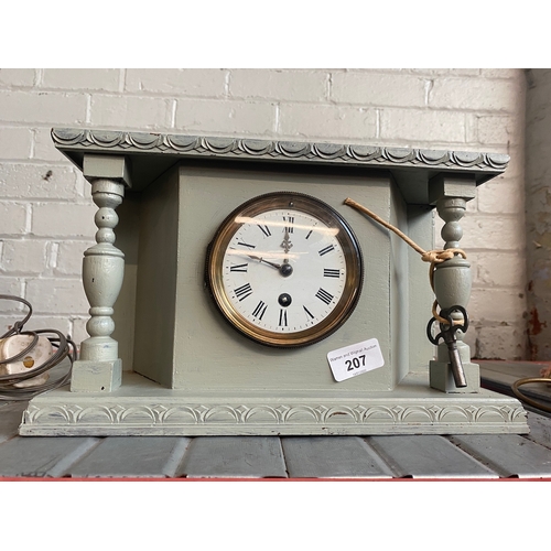 207 - A mantel clock with pendulum and key.