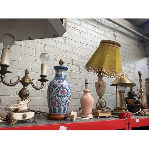 211 - A collection of table lamps to include brass, etc.