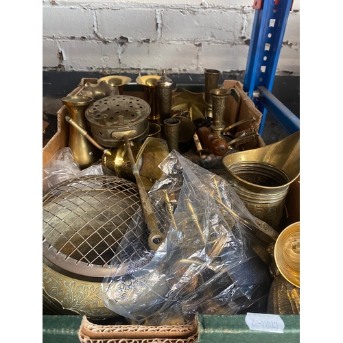 226 - A box of brassware including brass vases etc.