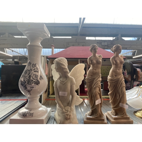 248 - A pair of classical figures, a fairy statue and a jardiniere stand