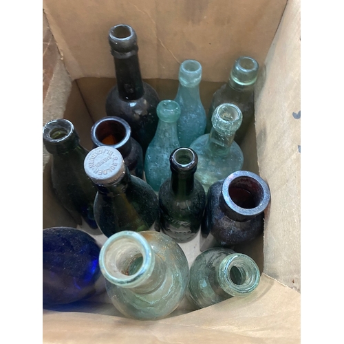 142 - A box of old bottles.