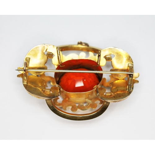 101 - A 19th century yellow metal brooch of scroll form and set with an oval mixed cut orange citrine weig... 