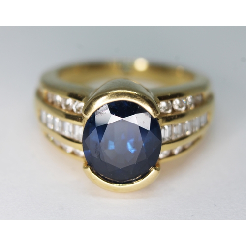 122 - A sapphire and diamond ring, the central oval mixed cut sapphire weighing approx. 3.90 carats, diamo... 