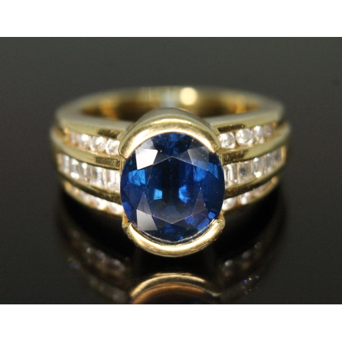 122 - A sapphire and diamond ring, the central oval mixed cut sapphire weighing approx. 3.90 carats, diamo... 