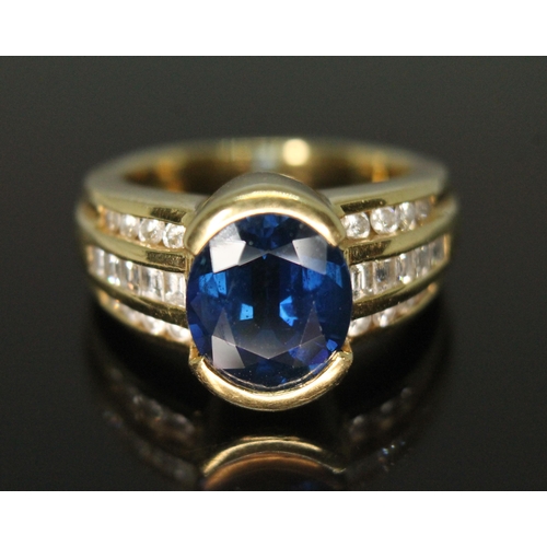 122 - A sapphire and diamond ring, the central oval mixed cut sapphire weighing approx. 3.90 carats, diamo... 