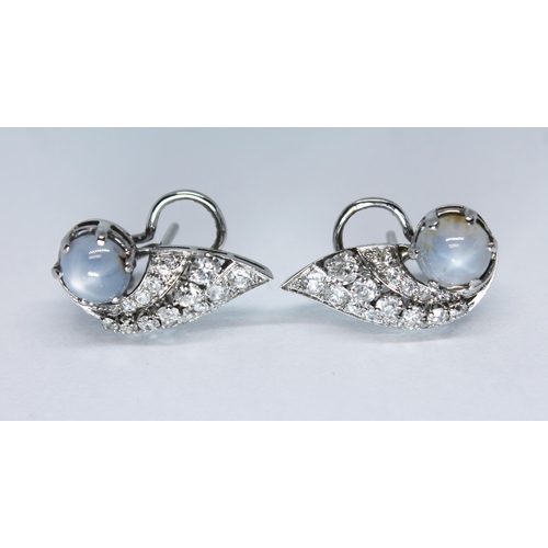 123 - A pair of French Art Deco style star sapphire and diamond earrings, of winged form with three rows o... 