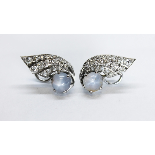 123 - A pair of French Art Deco style star sapphire and diamond earrings, of winged form with three rows o... 