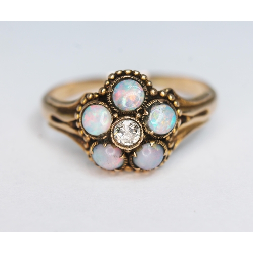 144 - A precious opal and diamond ring, the cluster measuring approx. 11mm in diameter, band unmarked, gro... 