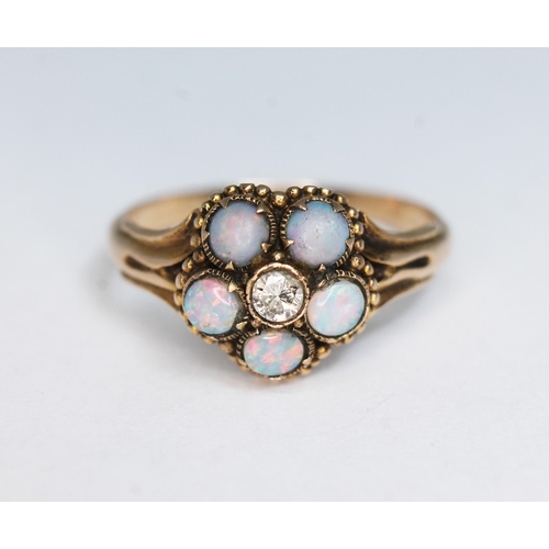 144 - A precious opal and diamond ring, the cluster measuring approx. 11mm in diameter, band unmarked, gro... 