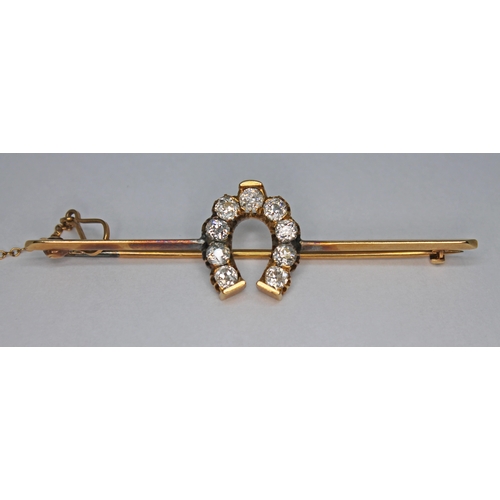 163 - A diamond set bar brooch, the nine Old European cut stones set within a horseshoe and weighing appro... 