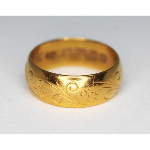 166 - An early 20th century 22ct gold wedding band, engraved design to exterior, sponsor's mark 'J.M.', Bi... 