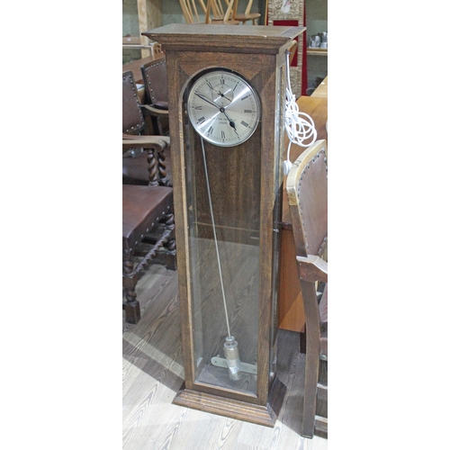 59 - A Venner Time Switches Ltd electric regulator clock, oak case, length 139cm.