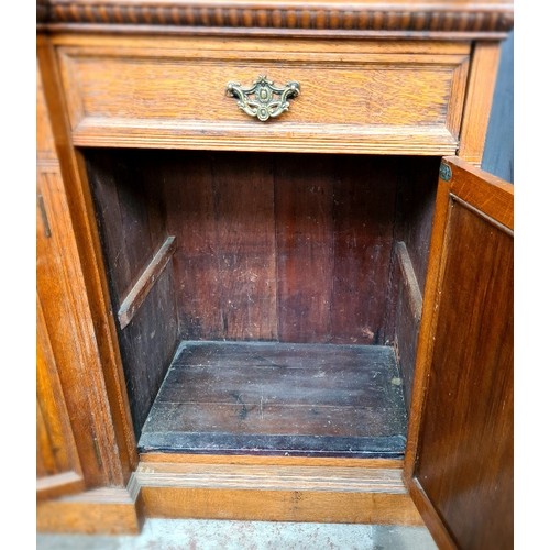 25 - A Victorian oak breakfront bookcase, the interior having adjustable shelves, width 257cm, depth 51cm... 