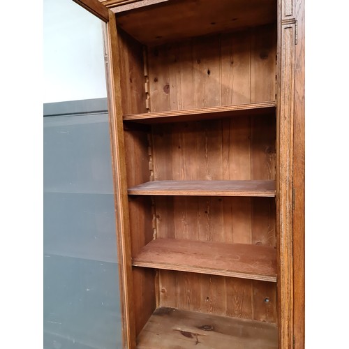 25 - A Victorian oak breakfront bookcase, the interior having adjustable shelves, width 257cm, depth 51cm... 