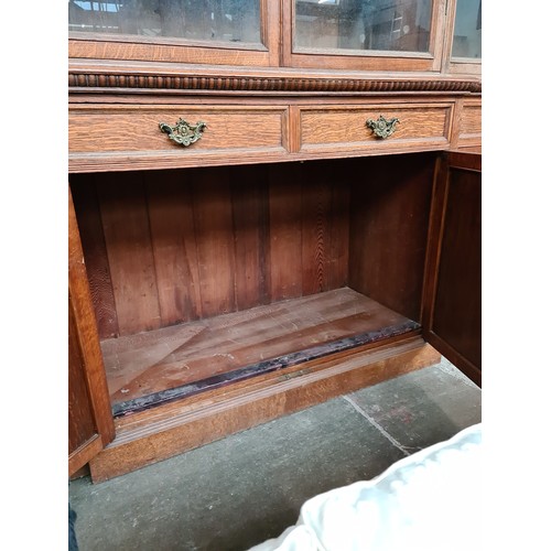 25 - A Victorian oak breakfront bookcase, the interior having adjustable shelves, width 257cm, depth 51cm... 