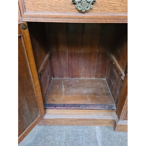 25 - A Victorian oak breakfront bookcase, the interior having adjustable shelves, width 257cm, depth 51cm... 