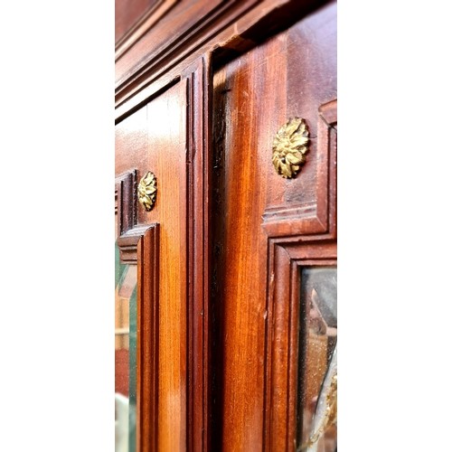 23 - A continental gilt mounted walnut armoire with mirrored doors, width 126cm, depth 48cm & height 233c... 