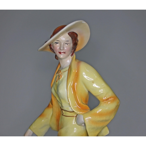 216 - An Art Deco Goldscheider style figure of a woman walking two borzoi dogs, height 35cm and width 37cm... 