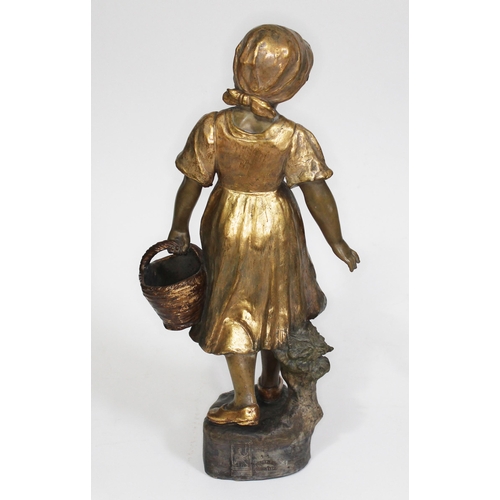 220 - A Goldscheider terracotta and gilt highlighted figure of a girl holding a basket by B. Haniroff, sta... 