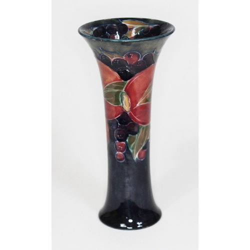 226 - A Moorcroft pottery vase of slender form with flared rim decorated in pomegranate pattern, height 19... 