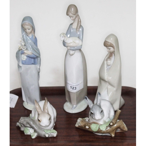 123 - A group of 5 Lladro figures. Rabbit 4772; Rabbit4773; Girl holding Lamb 4505; Girl holding Lilies 46... 