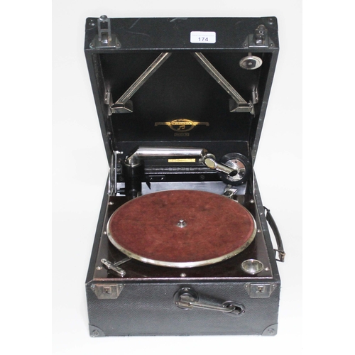 174 - A Columbia Granfola 112A portable gramophone and a bundle of old records.