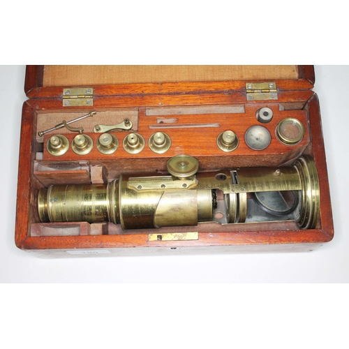 180 - An antique brass microscope no 209 by J H Steward, 406 Strand, London, in fitted wooden case with ac... 