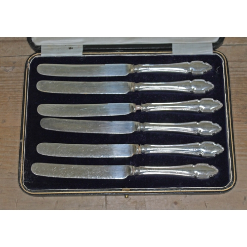 404 - A cased set of six silver handled knives.