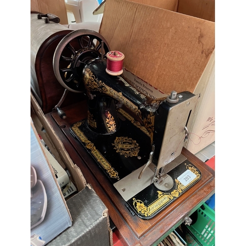 203 - A hand-cranked Singer sewing machine in wooden case.