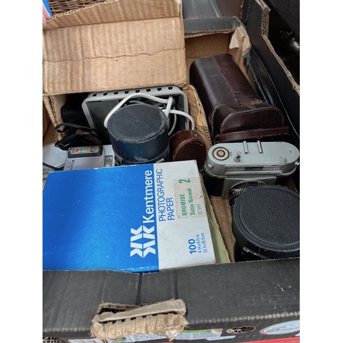 215 - A box of cameras and accessories, lenses, etc.