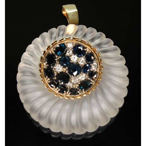 154 - A contemporary diamond, sapphire and rock crystal quartz pendant, formed from a gadrooned outer ring... 