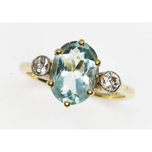 102 - An aquamarine and diamond ring, the central six claw set oval cut stone weighing approx. 1.77ct, mou... 