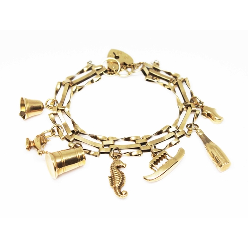 113 - A 9ct gold charm bracelet, six hallmarked 9ct gold charms and another unmarked, gross wt. 12.9g.