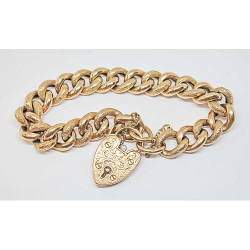 125 - An early 20th century half engraved link bracelet with heart shaped pad lock clasp, maker's mark 'J.... 