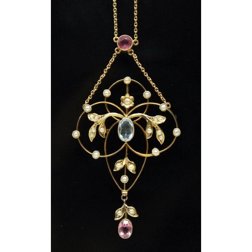 127 - An Edwardian pink tourmaline, seed pearl and aquamarine pendant of typical form with central millegr... 