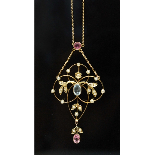 127 - An Edwardian pink tourmaline, seed pearl and aquamarine pendant of typical form with central millegr... 