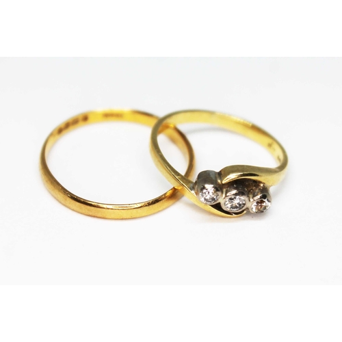 148 - A hallmarked 22ct gold wedding band wt. 1.5g and a hallmarked 18ct gold three stone diamond ring wt.... 