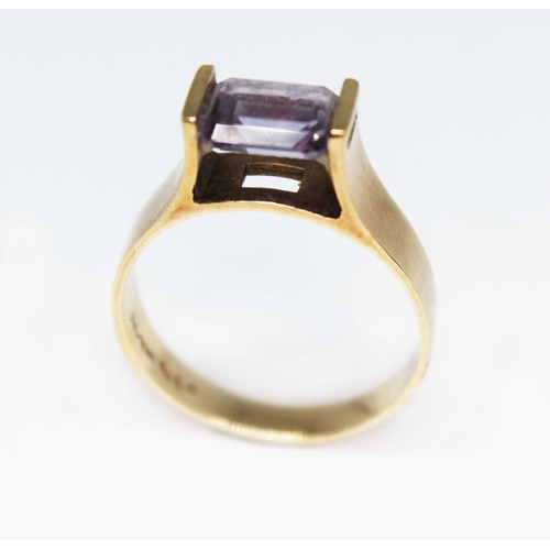 160 - A modern ring set with an emerald cut amethyst, marked 'Jayem 9ct', gross wt. 3.5g, size Q.