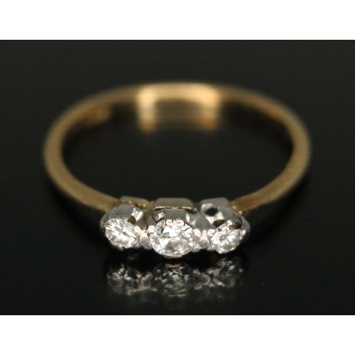 167 - A three stone diamond ring, marked '18', gross wt. 2.2g, size P.